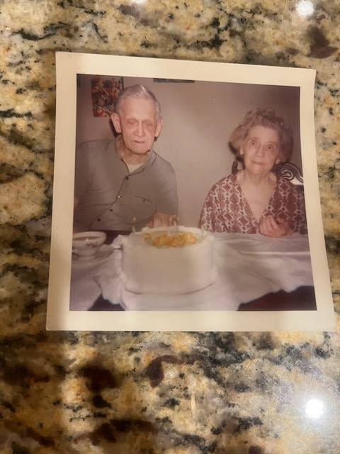 Dennis and Leona Tuttle with a cake, 1960s